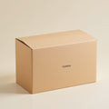 Kraft E-flute corrugated shipping box with a small minimal printed logo, plain brown finish